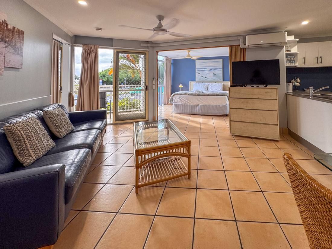 Deluxe apartment open-plan living area with ocean-facing balcony